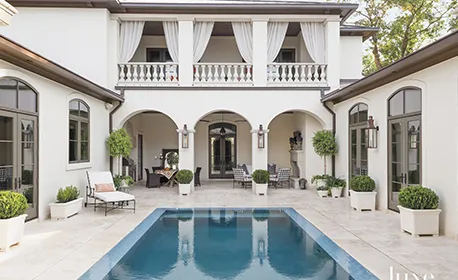 Elegant home with a pool and lush landscaping, highlighting home buying services in Doral, FL